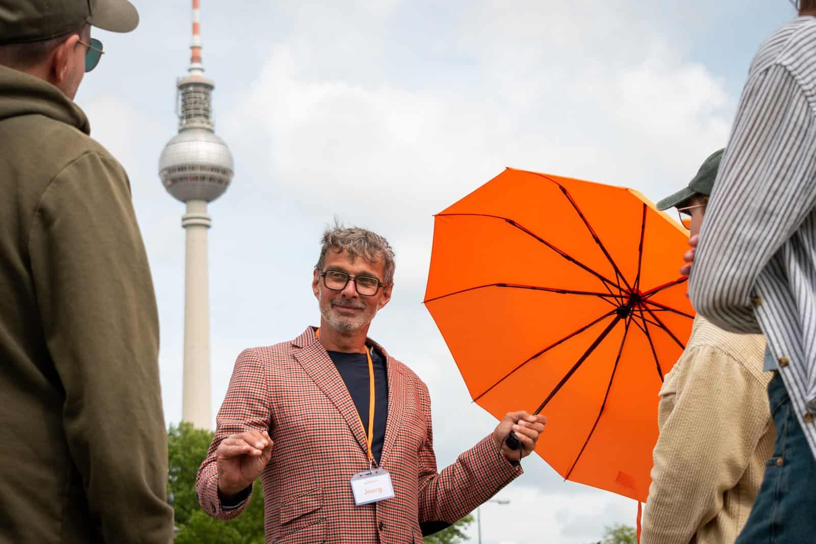 Local Tour guide standing in front of the TV tower in Berlin
